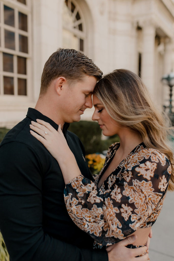 Couple leaning heads against each other engagement pose