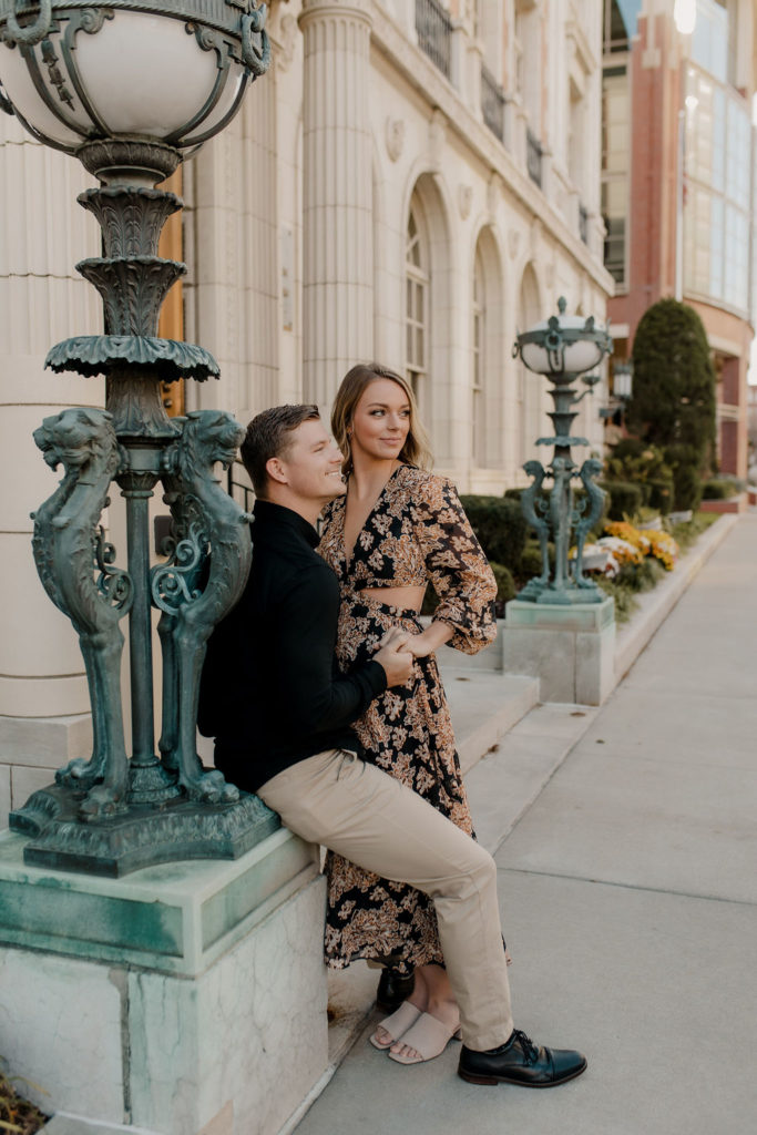 Engagement photo of couple in formal outfits in downtown Kansas City
