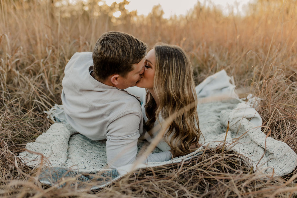 Couple kissing on picnic blanket
