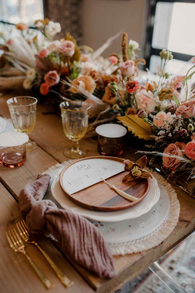 Boho wedding table setting with florals and flatlays