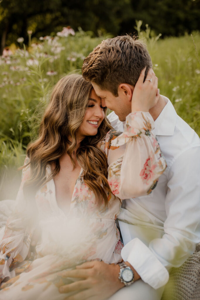 Couple embracing in field of wildflowers